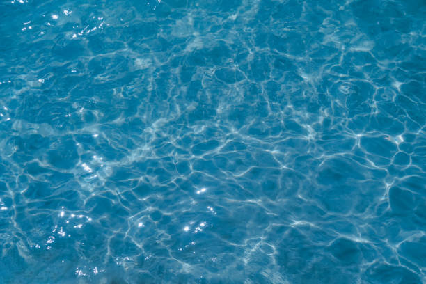 istock Overhead view of blue water surface abstract. Wave on moving water surface close up in the middle of the screen. Blue ocean water with waves background 2196608953