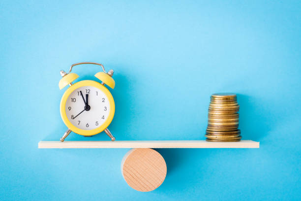 istock Time is money, Business concept. Blue background, scales with clock and stack of coins, copy space 2196609846