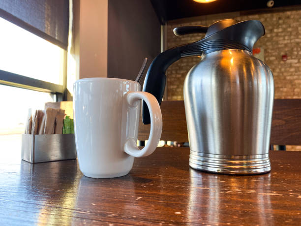istock Coffee cup and a pitcher on a table in a restaurant 2196611057
