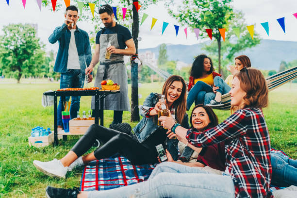 istock Friends having barbecue party among nature 2196612338