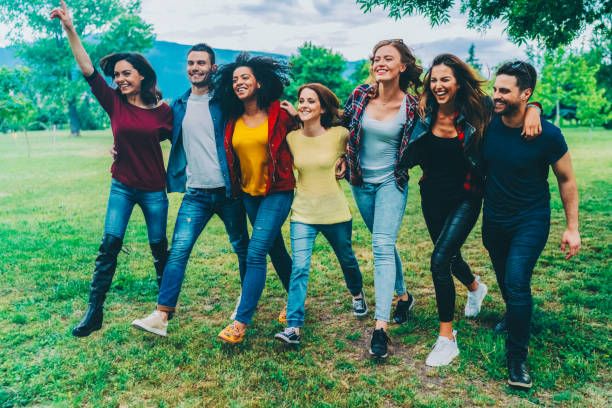istock Friends walking in the park 2196613101