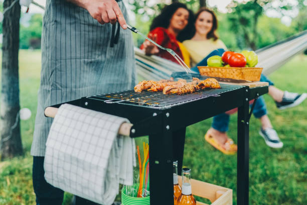 istock Friends having barbecue party among nature 2196613146