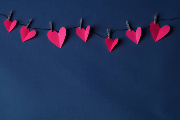 Paper hearts hanging on a clothesline with space for copy
