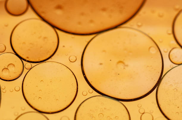 Gold and orange oil bubbles in water for backgrounds and graphics or abstract art