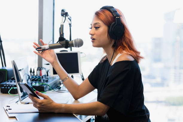 istock Young Woman Podcaster Using Laptop and Microphone 2196621301