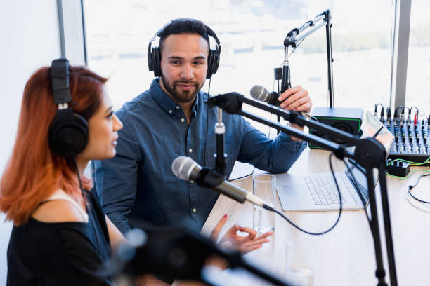 istock Two podcast hosts recording a show in a studio 2196621329