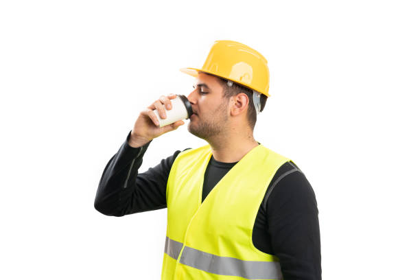 istock Male builder wearing work clothing drinking coffee from cup 2196623735