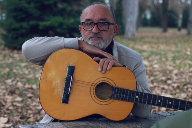istock Senior man learning to play guitar online 2196624367