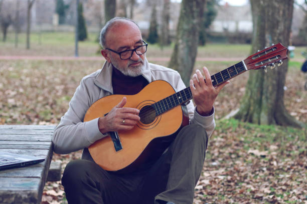 istock Senior man learning to play guitar online 2196624373