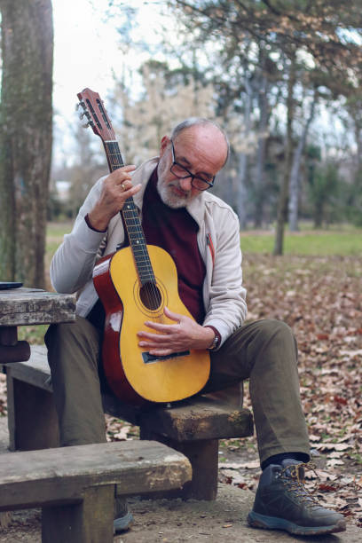 istock Senior man learning to play guitar online 2196624397