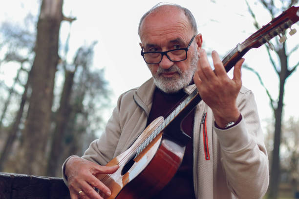 istock Senior man learning to play guitar online 2196624424