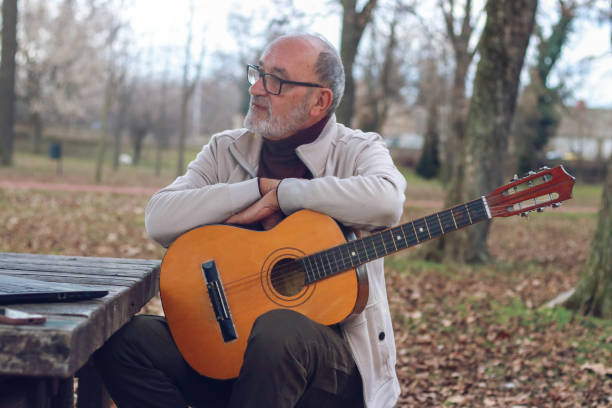 istock Senior man learning to play guitar online 2196624425