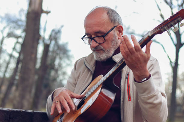 istock Senior man learning to play guitar online 2196624426