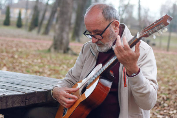 istock Senior man learning to play guitar online 2196624430