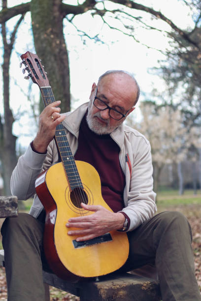 istock Senior man learning to play guitar online 2196624448