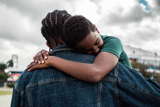istock Father embracing his son outdoors 2196627326
