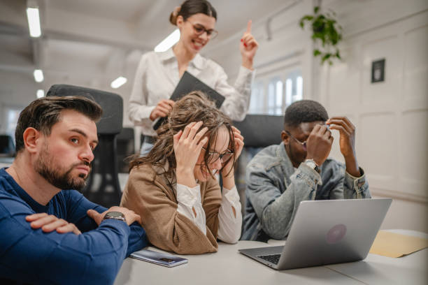 istock multicultural exhausted colleagues work together on laptop in the office 2196628413