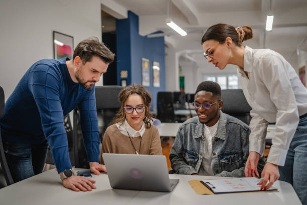 istock multicultural colleagues work together on laptop in the office 2196628911