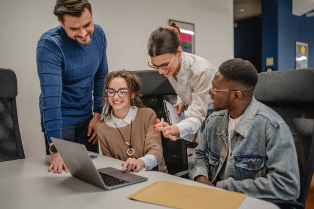 istock multicultural colleagues work together on laptop in the office 2196629023