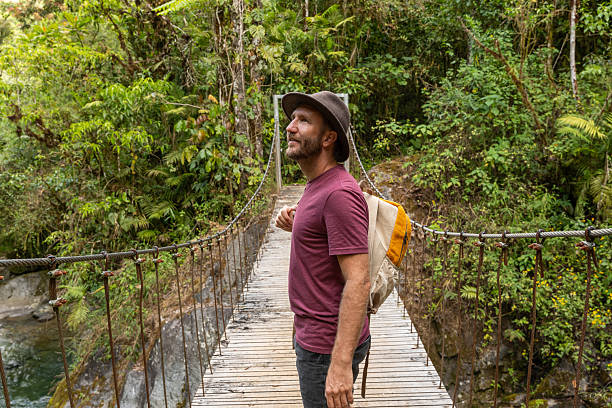 istock Traveler on Scenic Jungle Bridge Admiring River View 2196629693