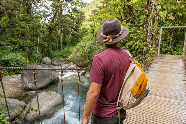 istock Traveler on Scenic Jungle Bridge Admiring River View 2196629698