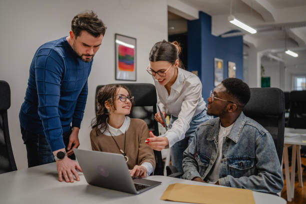 istock multicultural colleagues work together on laptop in the office 2196629728