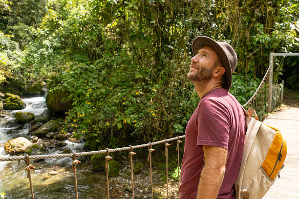 istock Traveler on Scenic Jungle Bridge Admiring River View 2196629793