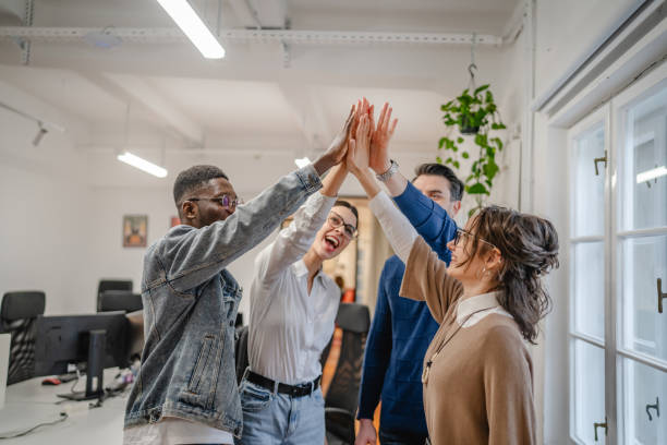 istock Positive motivated multicultural colleagues raise their hands together 2196629800