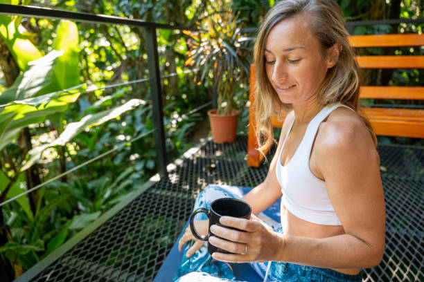 istock Woman Relaxing on Tropical Balcony with Coffee 2196631660