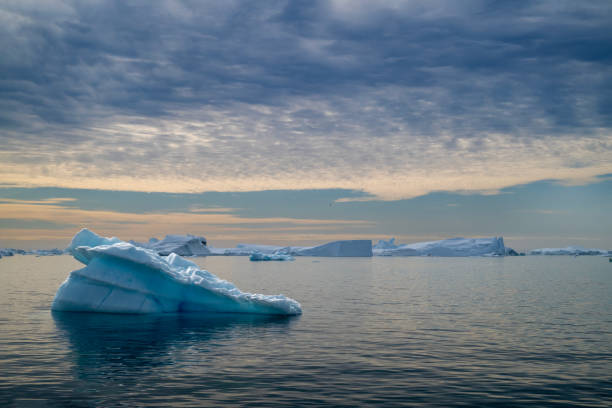 istock floating icebergs during a sunset in Disko Bay, during polar summer midnight solar season. Ilulissat, Greenland 2196633878