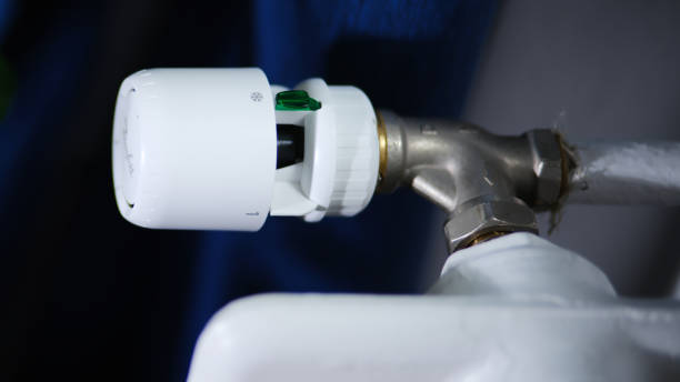istock White radiator valve with temperature control knob attached. 2196638825