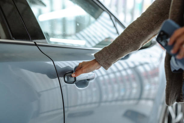 istock A person unlocking a parked car in a garage close-up 2196639326