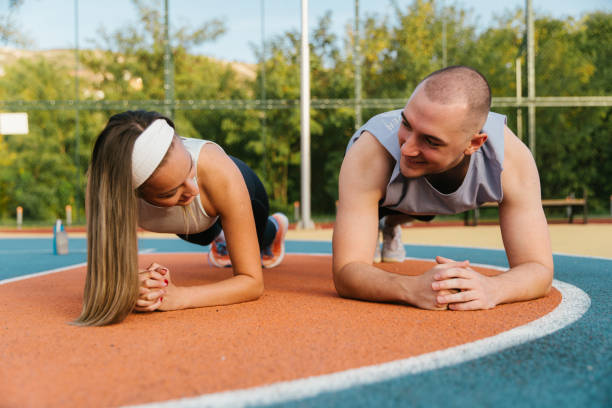 istock Couple excercise together on a sports field 2196643759