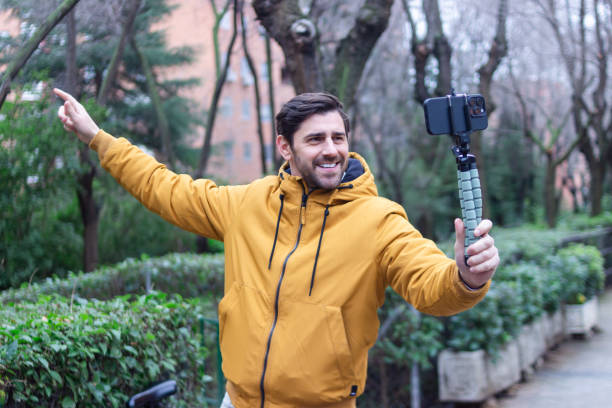 Influencer creating content with smartphone gimbal in park