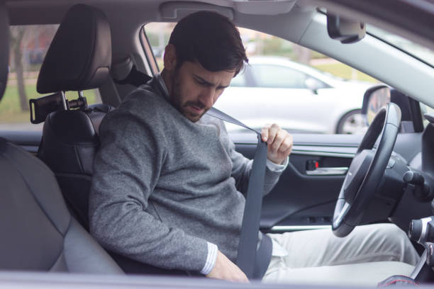 istock Businessman fastening seat belt while sitting inside car 2196644641
