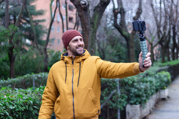 istock Content creator filming with smartphone gimbal in the city park 2196644825