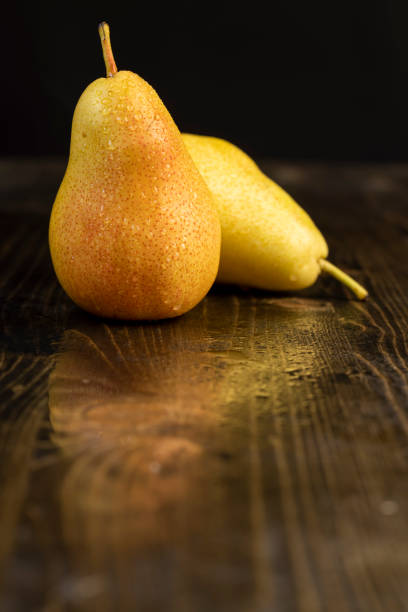 istock wet ripe yellow-red pears on the table 2196645255