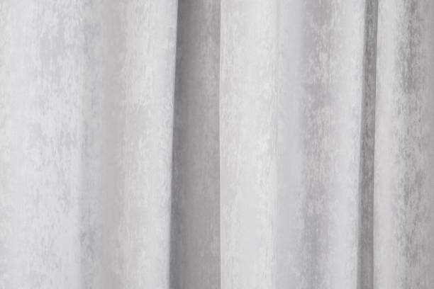istock Soft gray curtains hanging elegantly in a serene indoor setting 2196653467