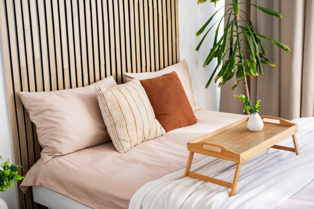 istock Modern bedroom with stylish decor and a cozy breakfast tray at morning light 2196653486
