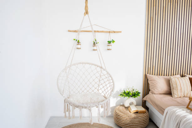 istock Cozy indoor space with a trendy hanging chair and natural decor elements 2196653503