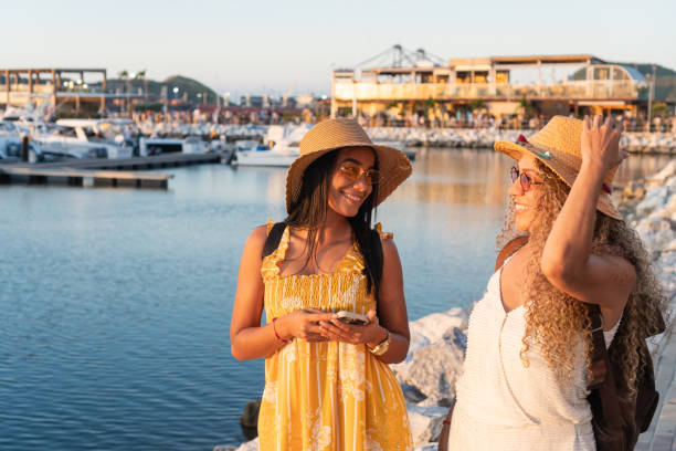 istock Two smiling tourists enjoying sunset at the marina 2196656248