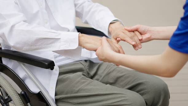 istock Caregiver's hands reaching out to the elderly 2196659646