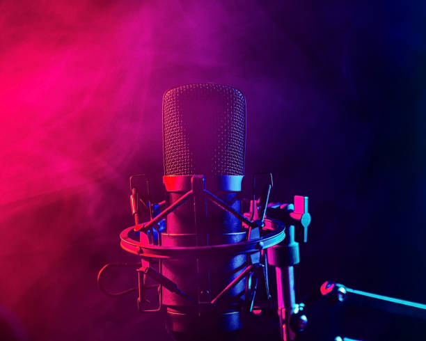 istock Professional microphone in pink smoke on a black background. 2196660990
