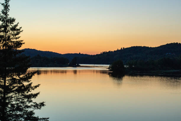 istock Tranquil Sunrise Over Serene Lake with Surrounding Forest Scenery 2196661926