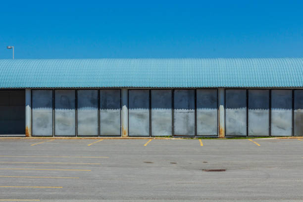 Empty warehouse with windows. Industrial building with high ceilings. 3D image