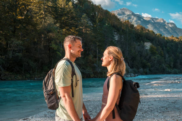 istock Caucasian Couple Holding Hands by the River in Nature 2196662029