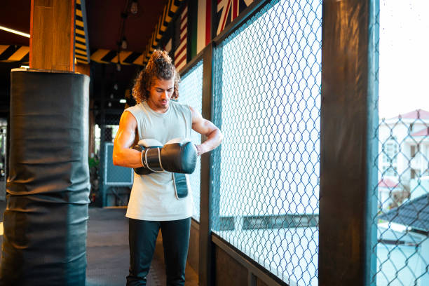 istock Hispanic Male Boxer Focusing Determinedly In Gym Training Session 2196662104