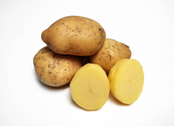 istock Some whole potatoes, and sliced ​​peeled potatoes, isolated on white background 2196667574