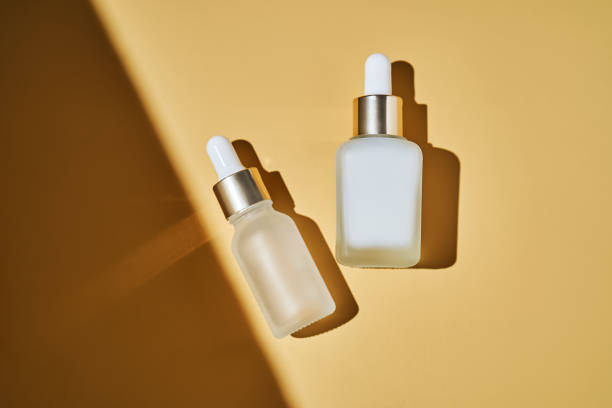 istock Two bottles of serum on a beige background with a beautiful shadow. 2196668288