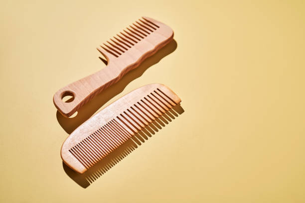 istock Two wooden combs on a yellow background. 2196668909